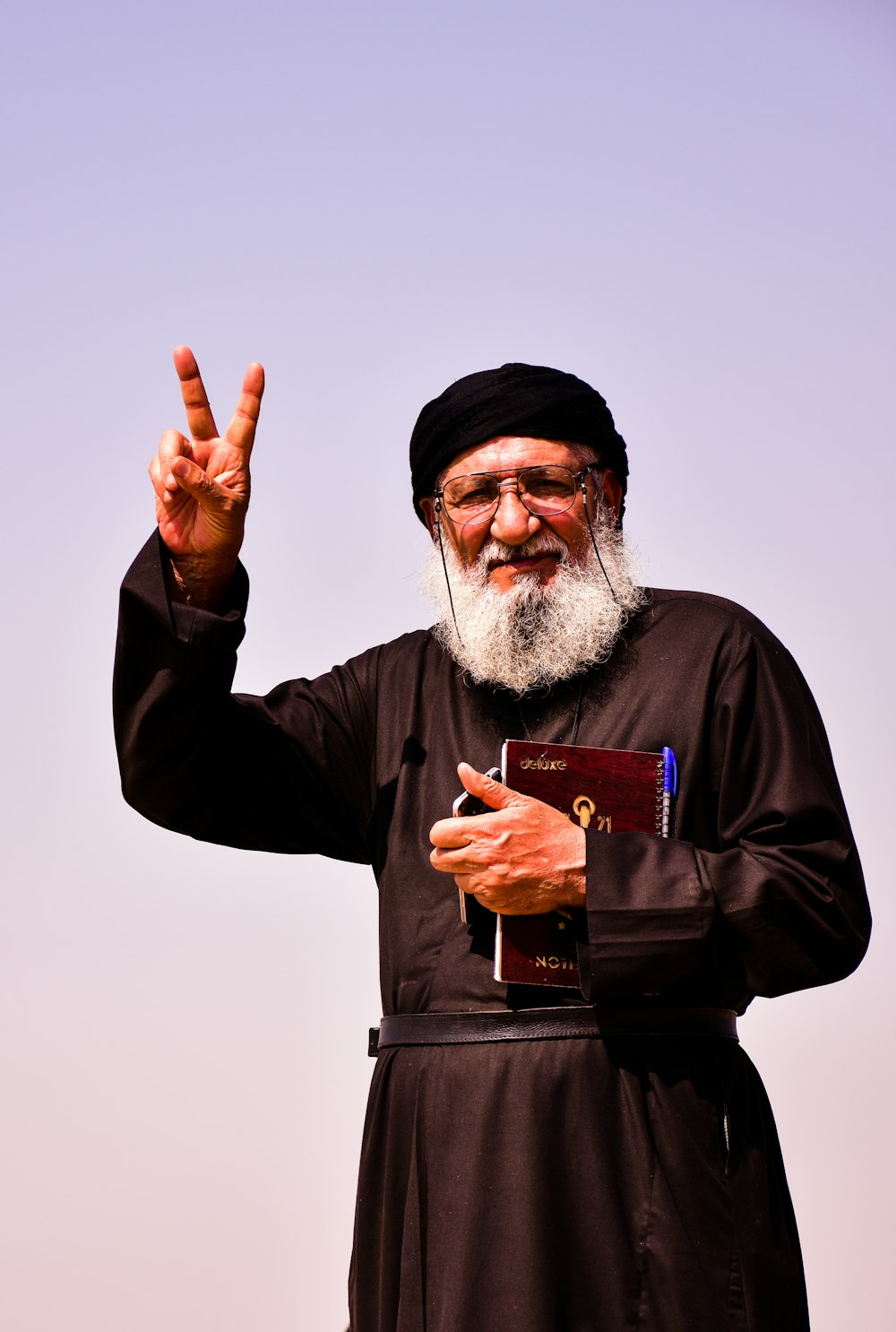 man in black long sleeve shirt holding red and white card