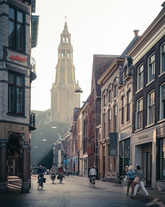 people walking on street between buildings during daytime