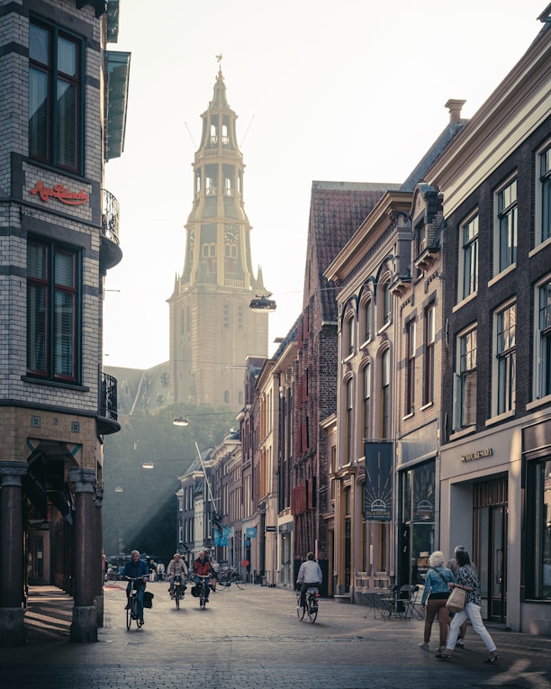 people walking on street between buildings during daytime