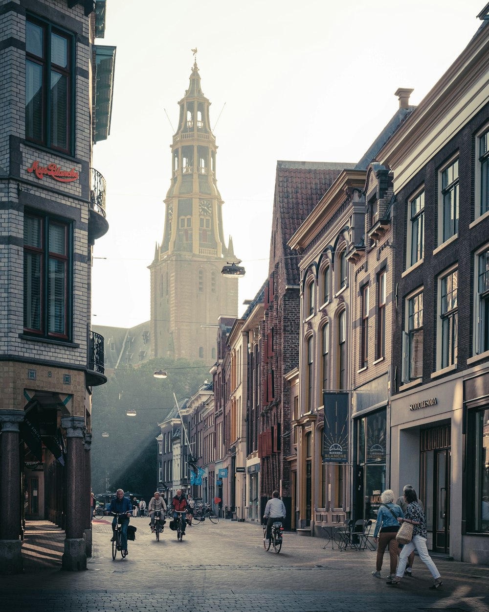 people walking on street between buildings during daytime