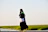 woman in white long sleeve shirt and black hijab standing on brown field during daytime