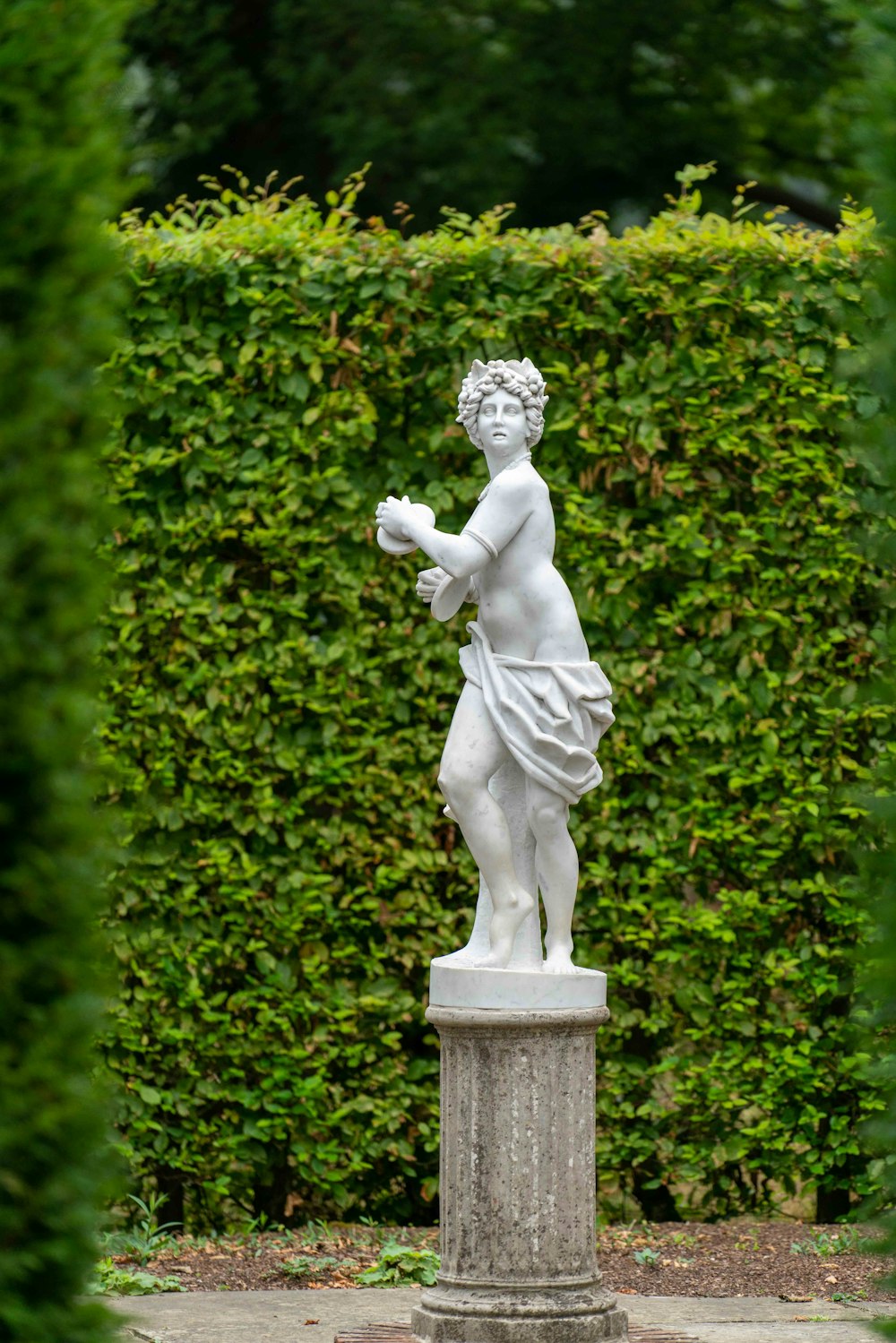 white concrete statue of a man