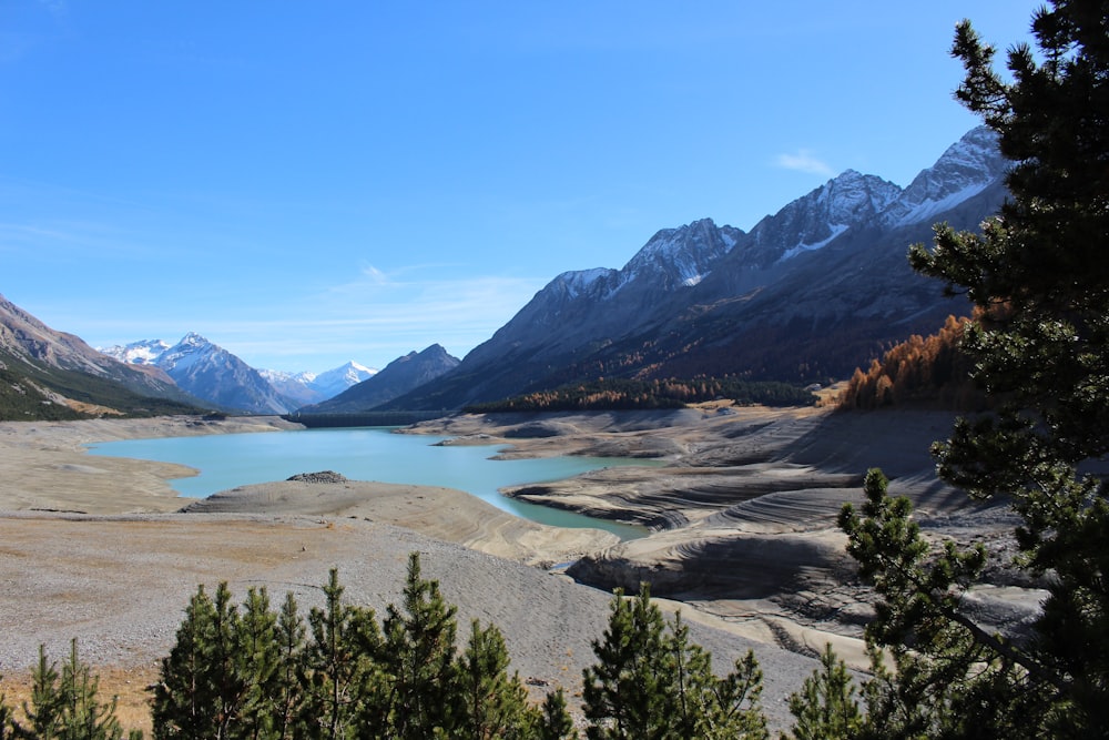 lake in the middle of mountains during daytime