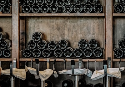 Rows of personalized wine and olive oil bottles beautifully arranged as wedding favors.