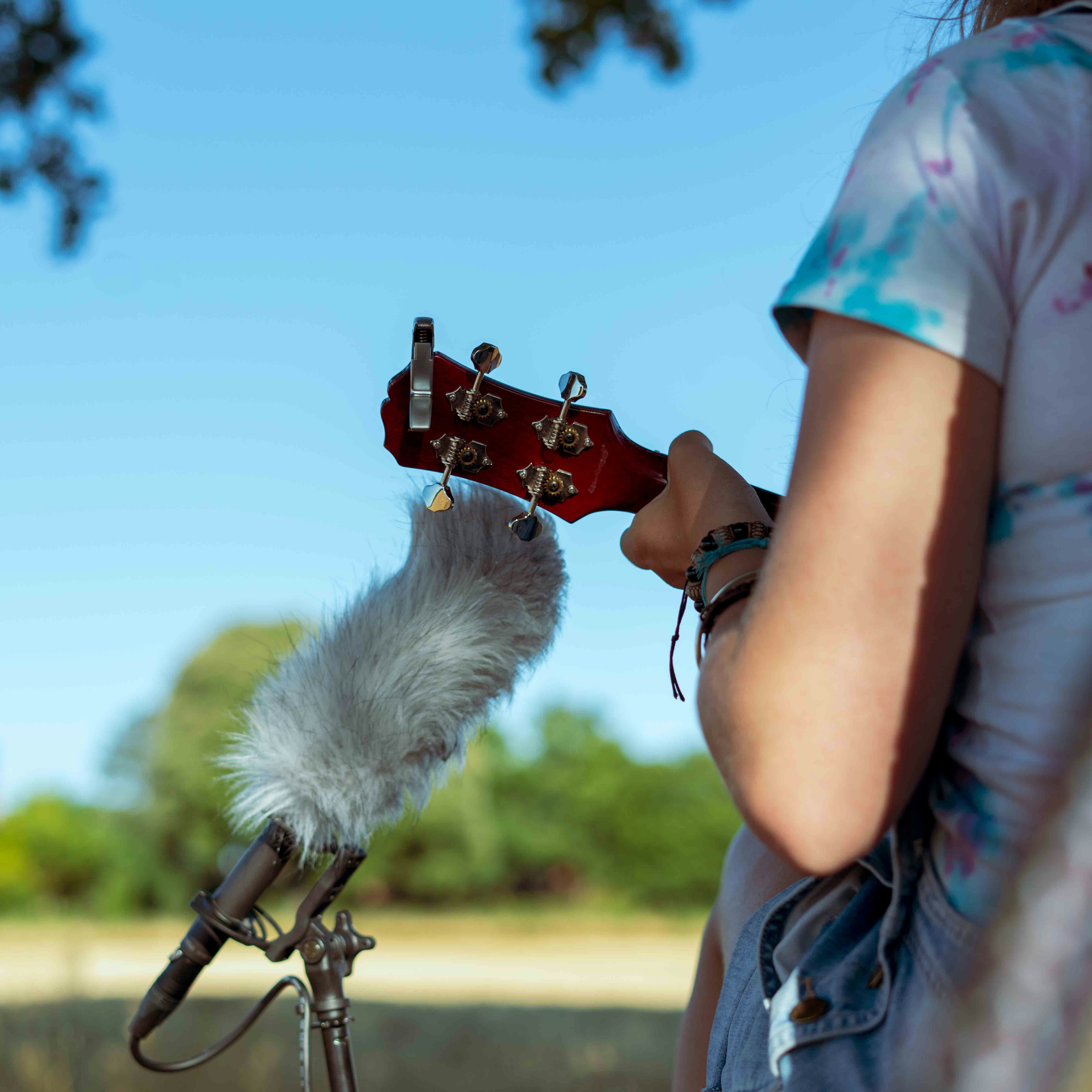 person in red and white t-shirt holding black and red dslr camera