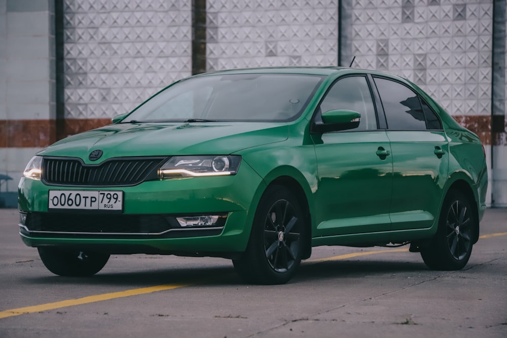 green volkswagen car parked on parking lot during daytime