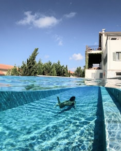 man in swimming pool during daytime