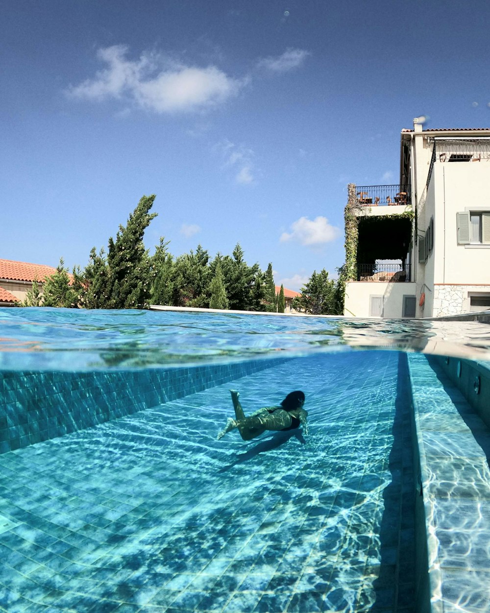 man in swimming pool during daytime