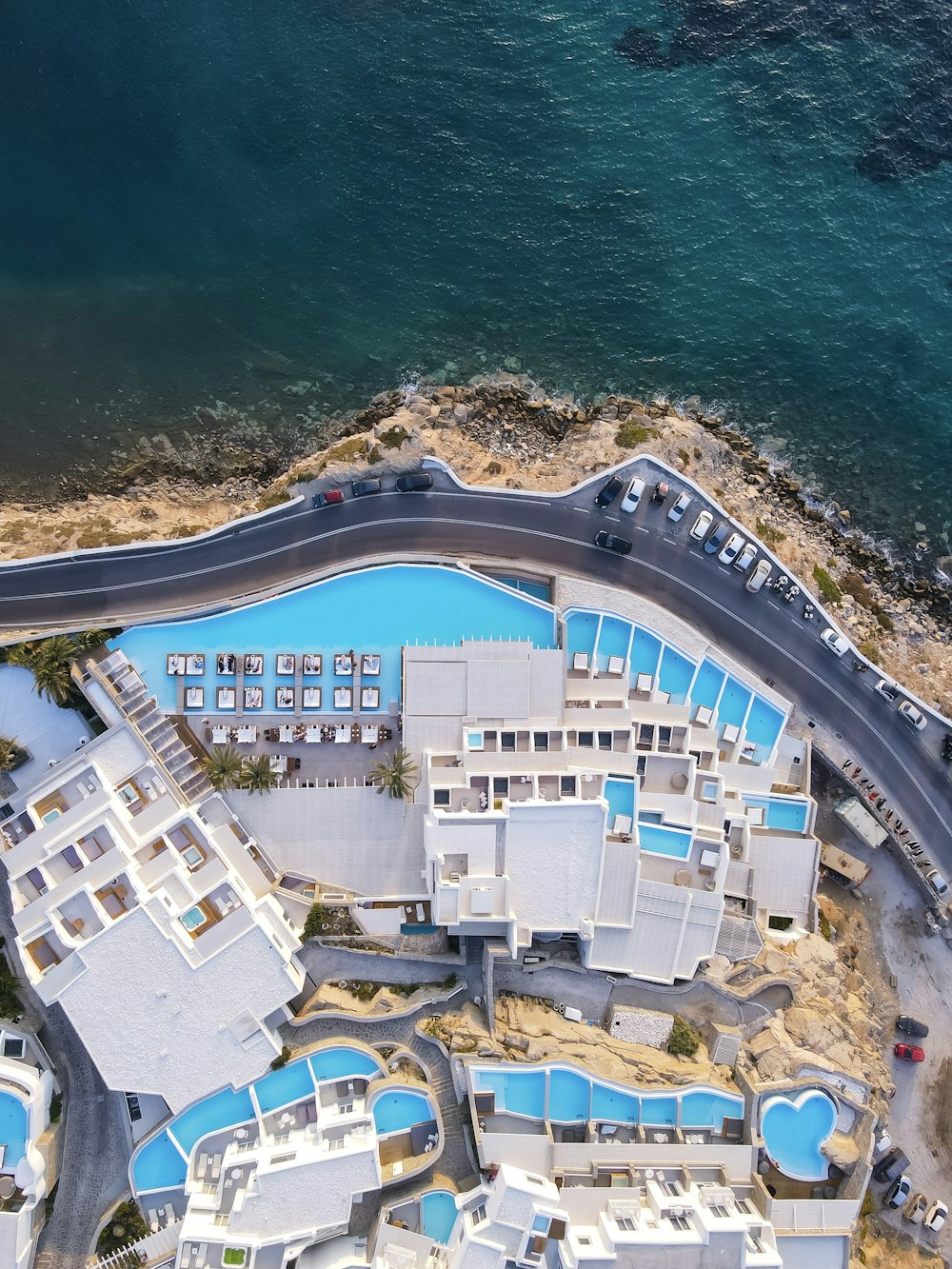 aerial view of white and blue building near body of water during daytime