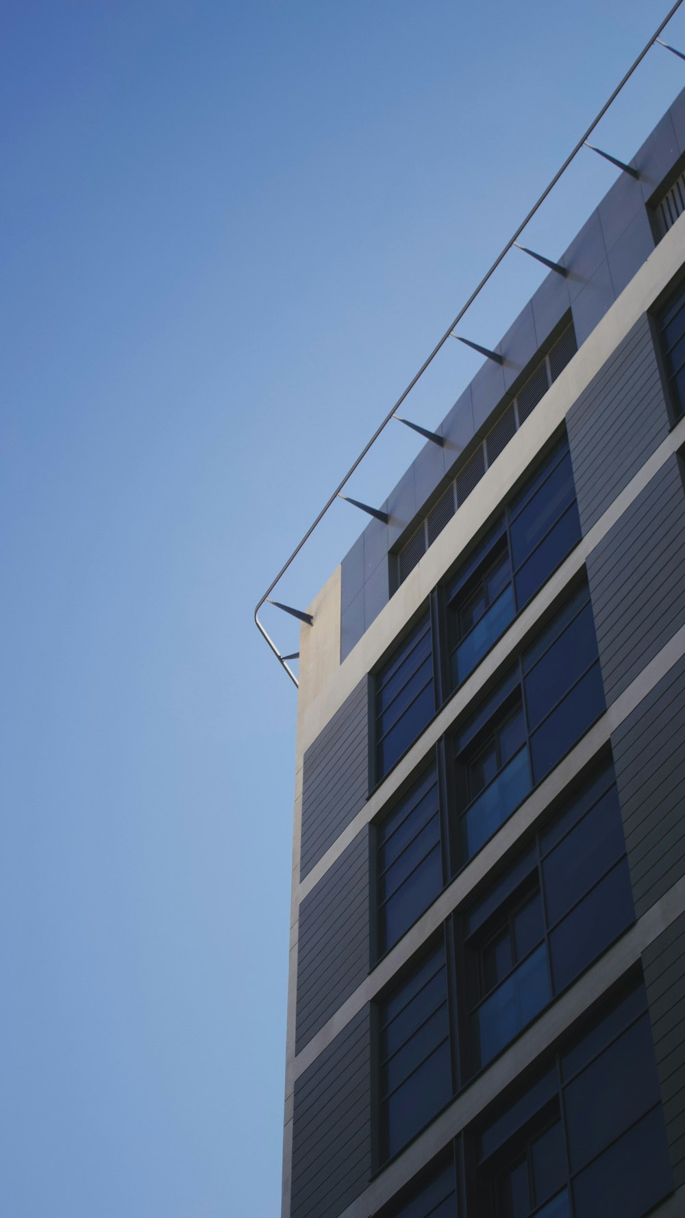 black and white concrete building under blue sky during daytime