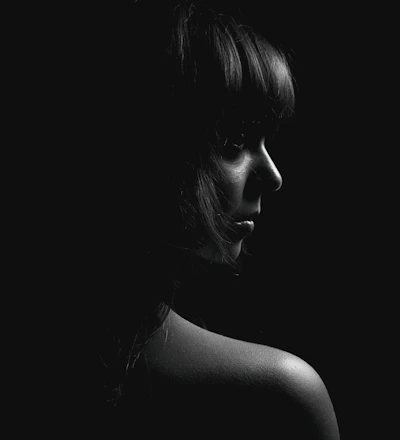 A high-resolution minimalist black and white portrait with soft natural lighting