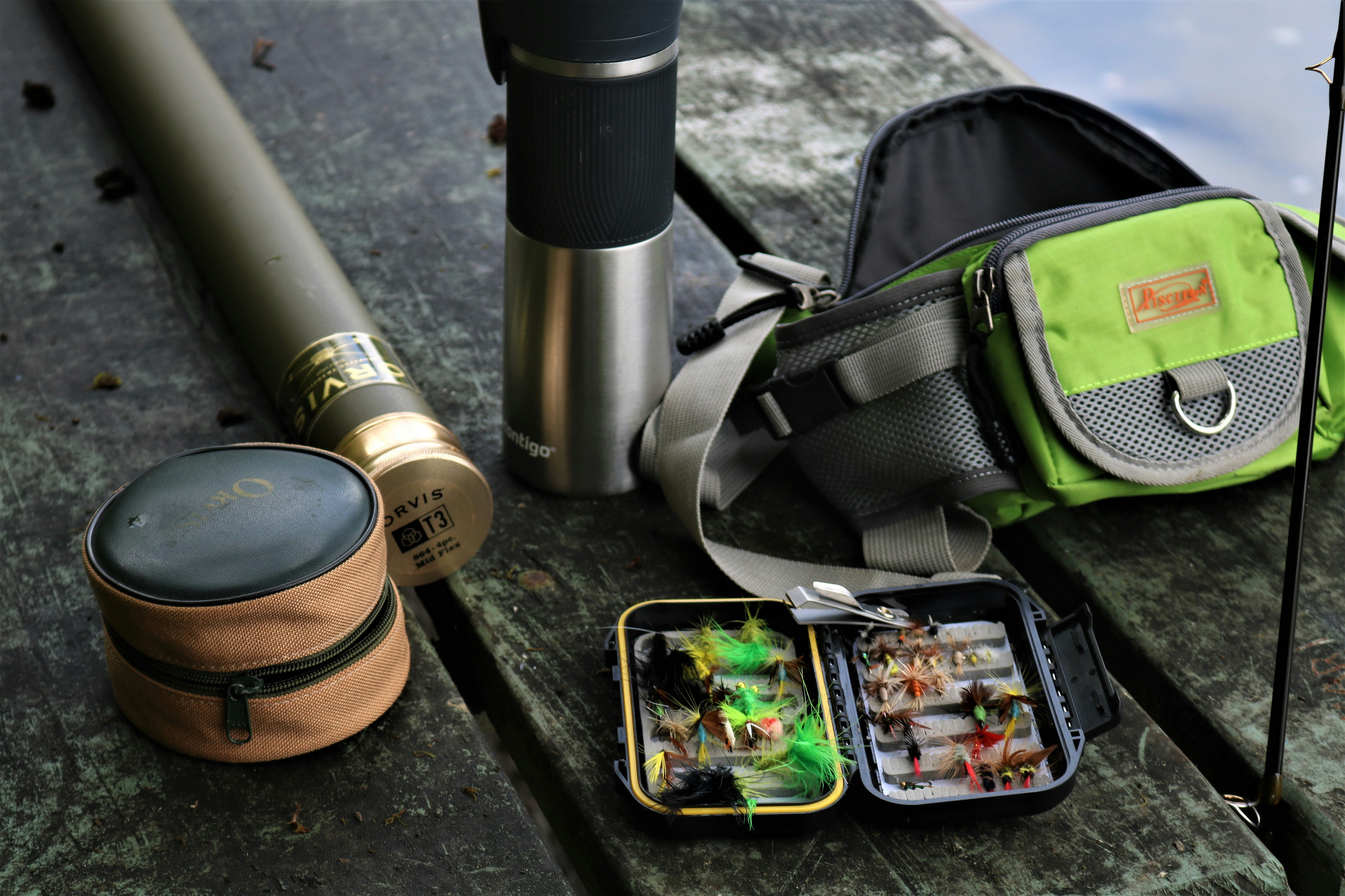 Essential safari gear including binoculars, camera, and travel adapter