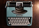 green and black typewriter on green table