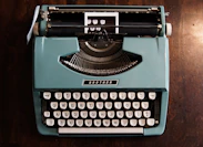 green and black typewriter on green table