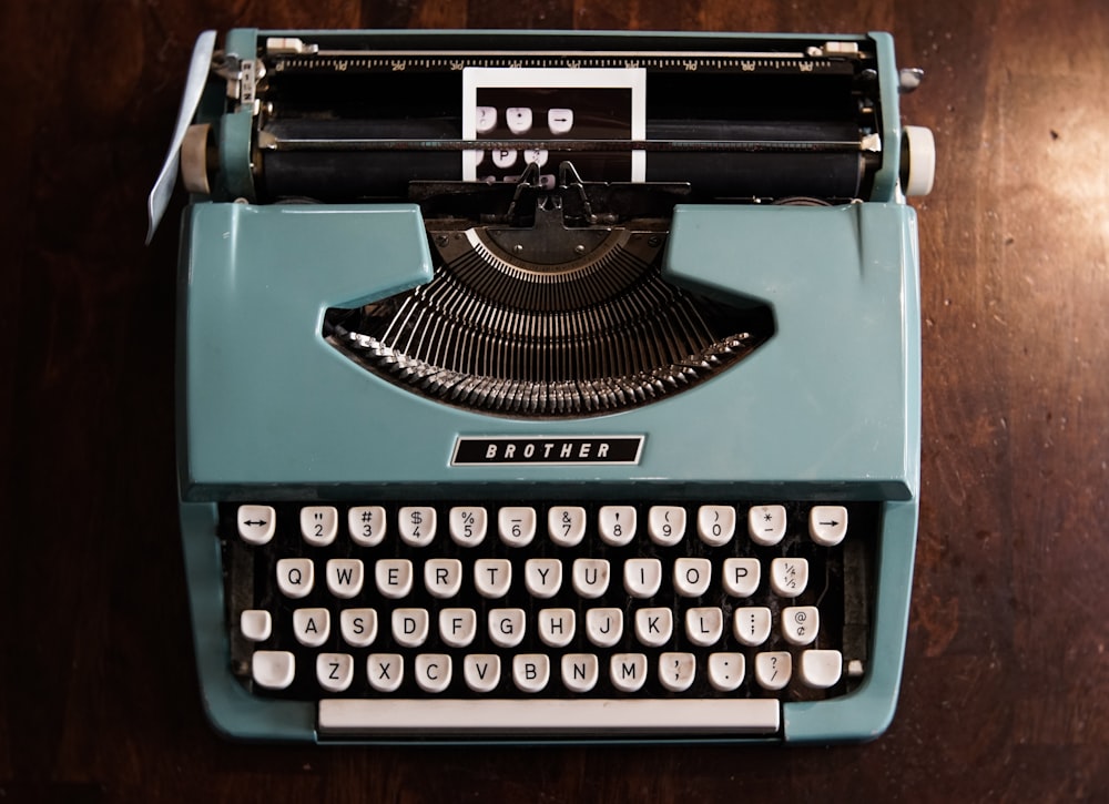 green and black typewriter on green table