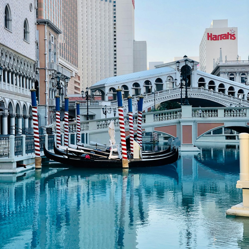 people riding on boat on river near buildings during daytime