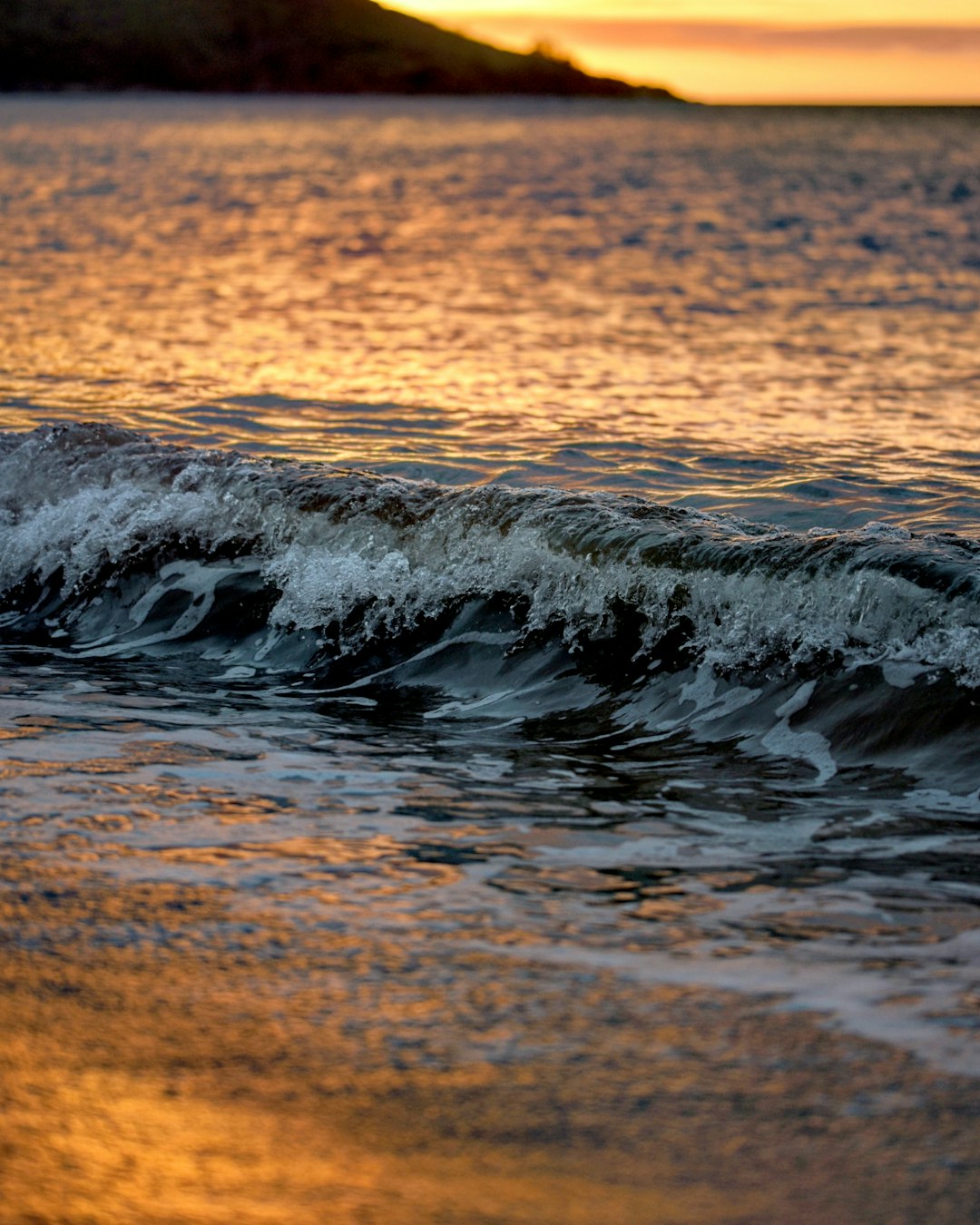 water waves on brown sand during daytime