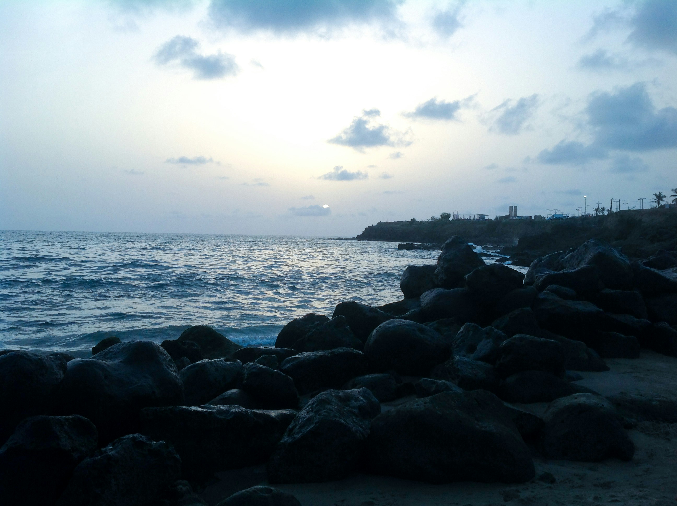 black rocks near body of water during daytime senegal teams background