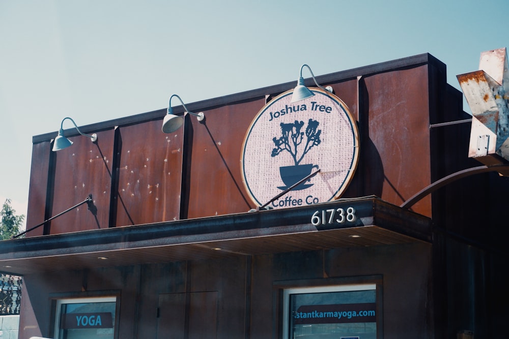 a coffee shop with a large sign above it