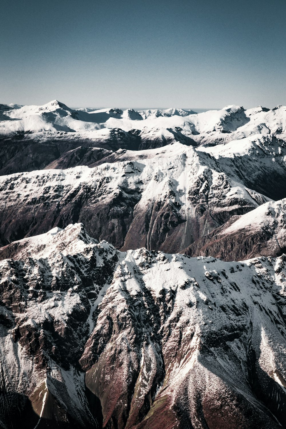 brown and white mountains under blue sky during daytime