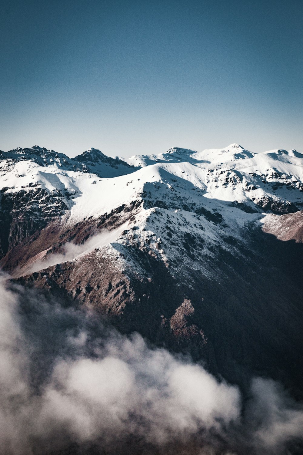 brown and white mountain under white clouds during daytime