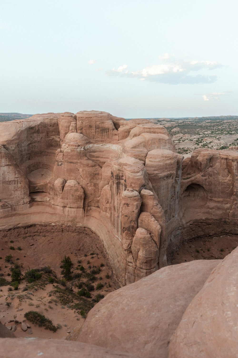 brown rock formation near body of water during daytime