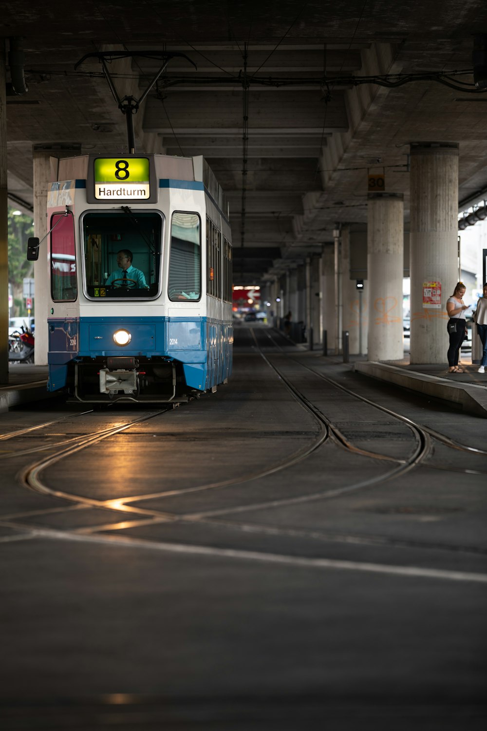 white and blue train on train station