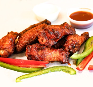 grilled meat with green vegetable on white ceramic plate