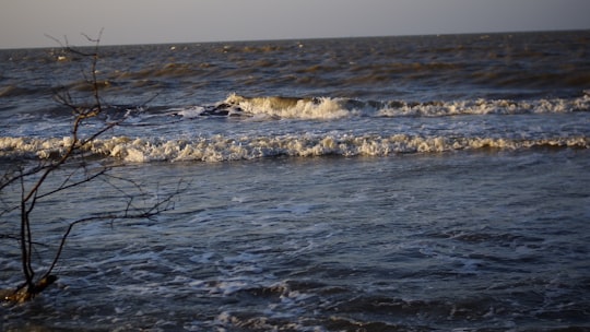 ocean waves crashing on shore during daytime in Subang Indonesia