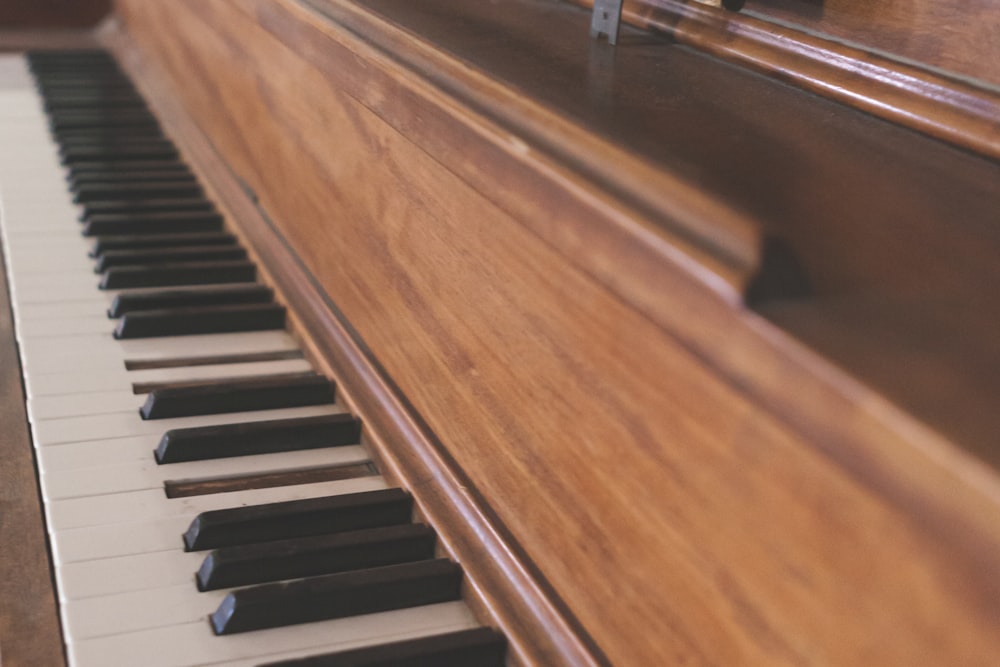 brown and white upright piano