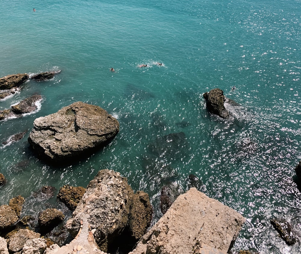 brown rock formation near body of water during daytime