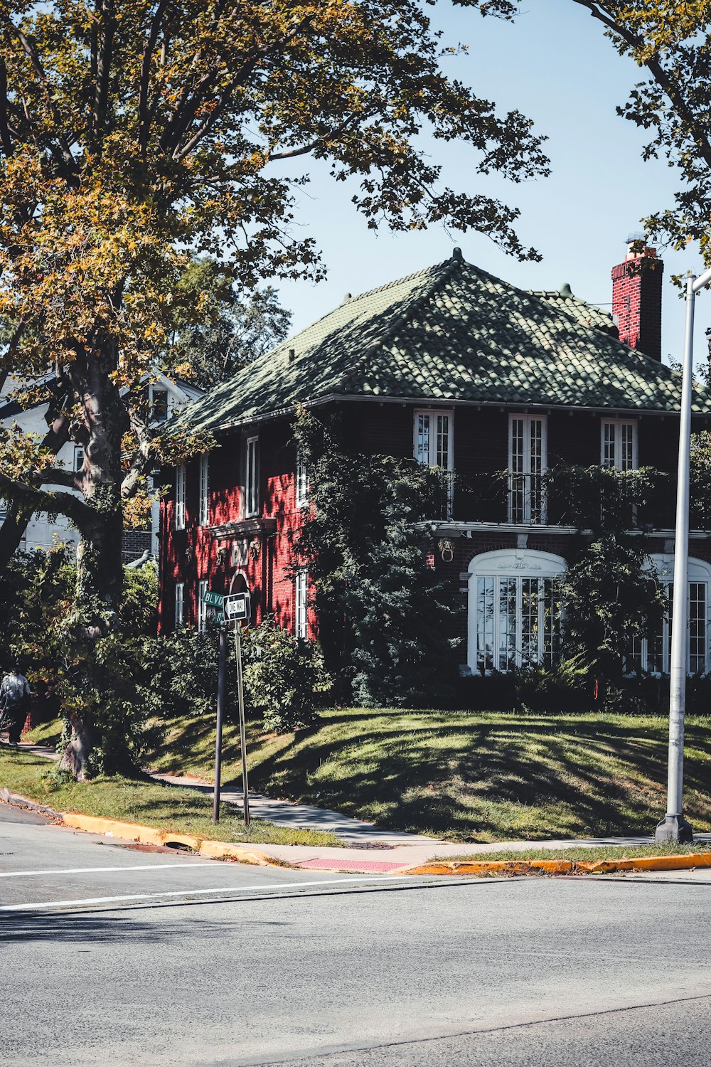 red and white wooden house near green trees during daytime