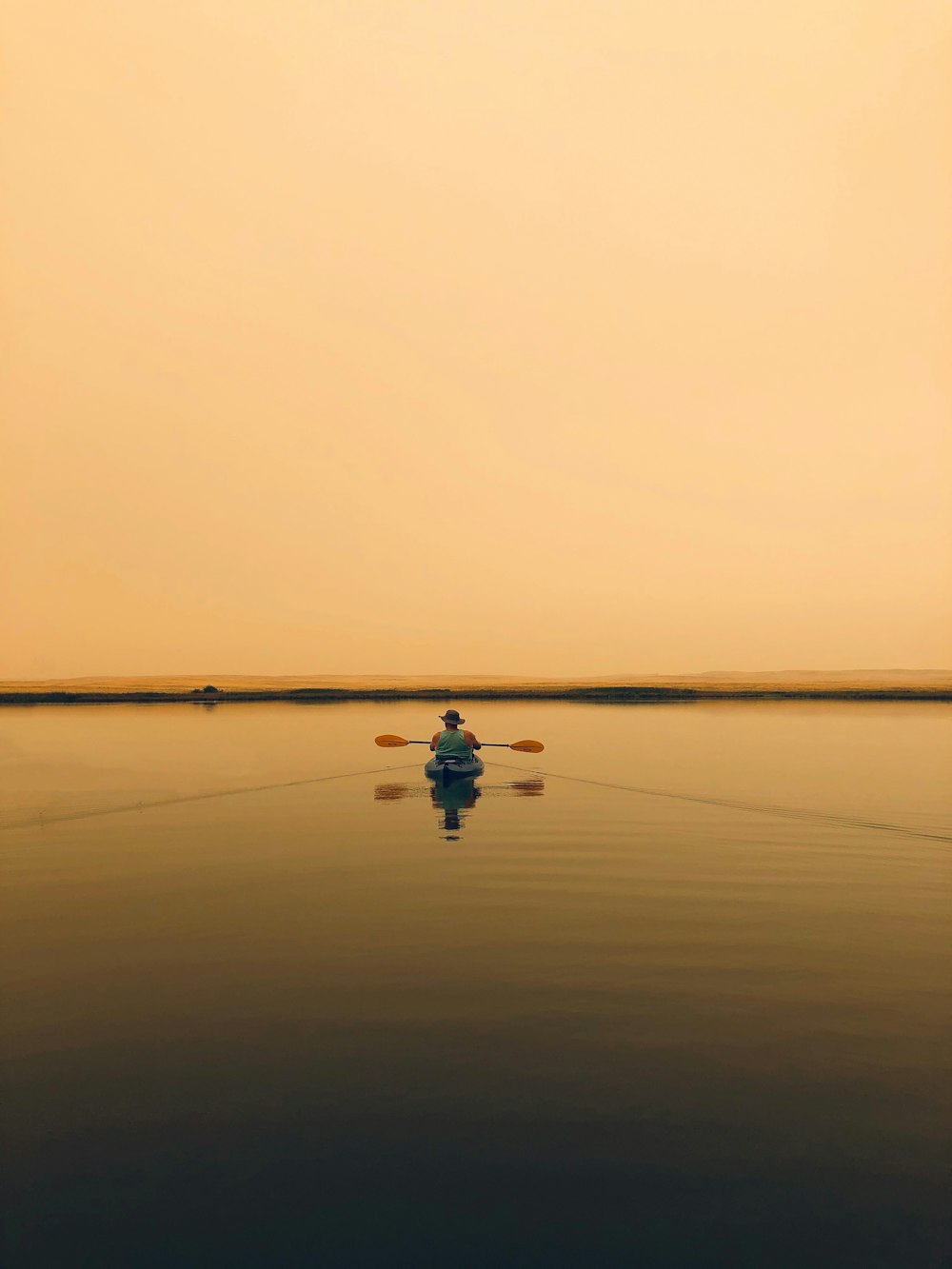 person in black shirt and blue denim jeans riding on boat on sea during daytime