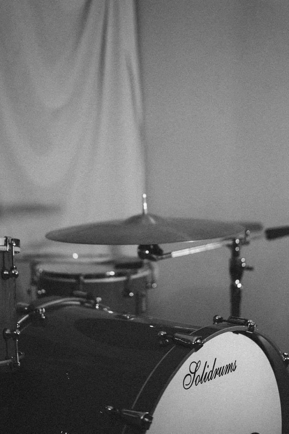 grayscale photo of drum kit