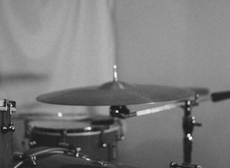 grayscale photo of drum kit
