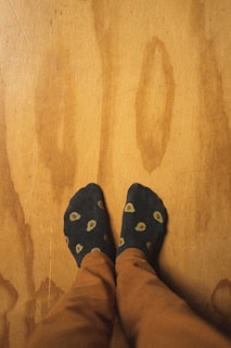 person wearing blue and yellow rubber clogs