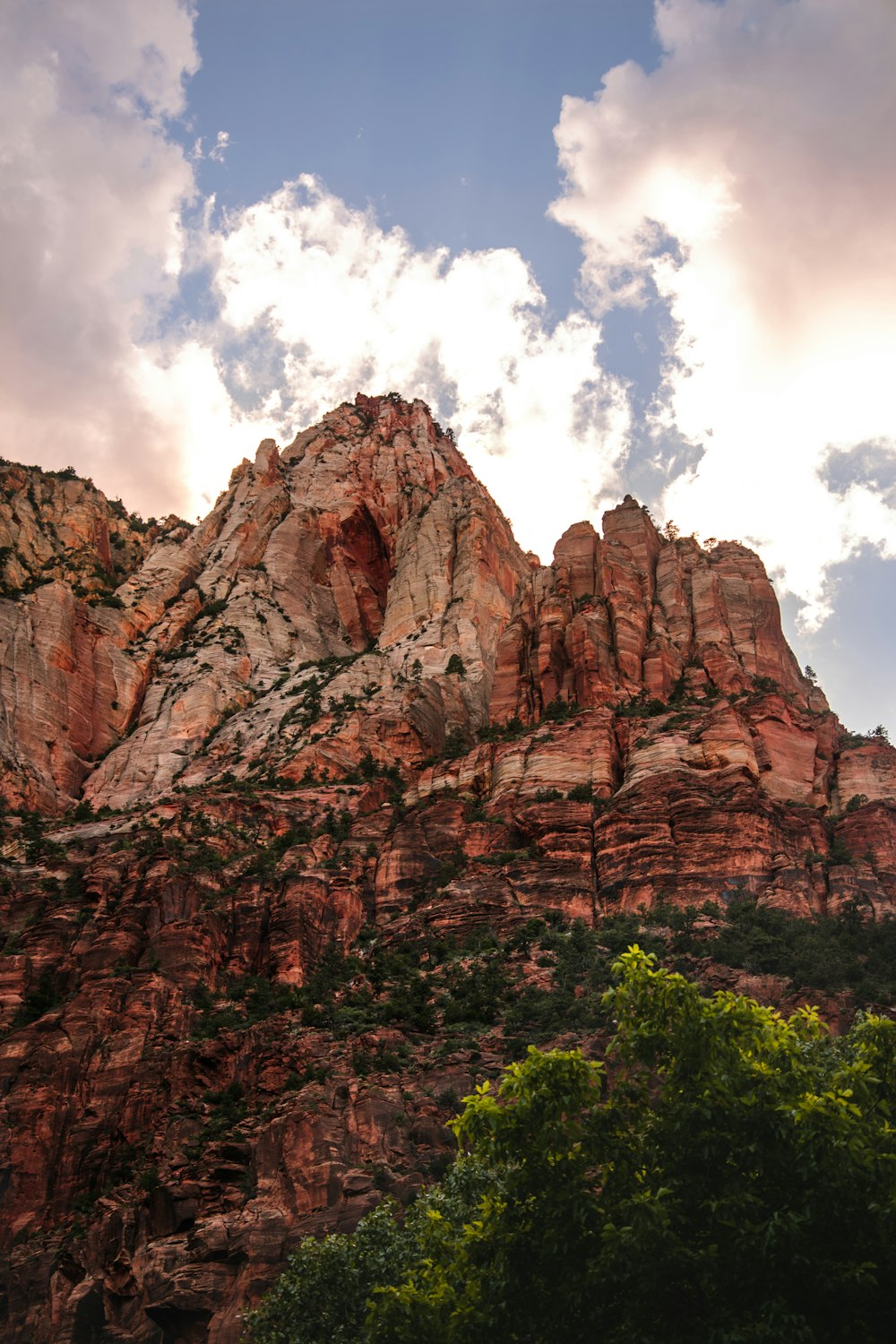 brown rocky mountain under blue sky and white clouds during daytime