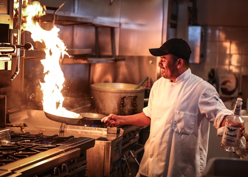 man in white chef uniform cooking