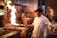 man in white chef uniform cooking