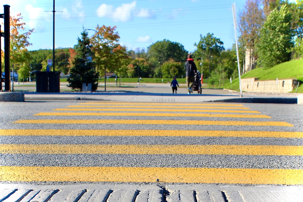 2 person walking on pedestrian lane during daytime