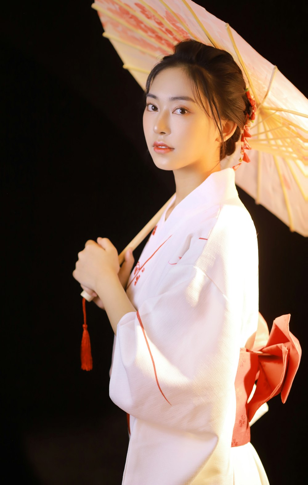 woman in white long sleeve shirt holding umbrella