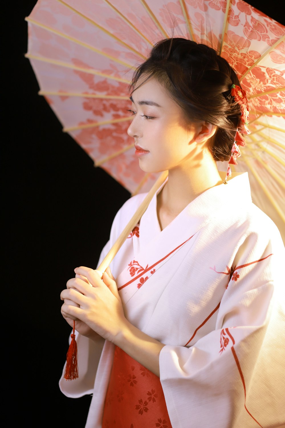 woman in white and red kimono holding umbrella