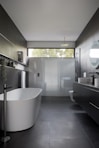white ceramic bathtub near white bathtub