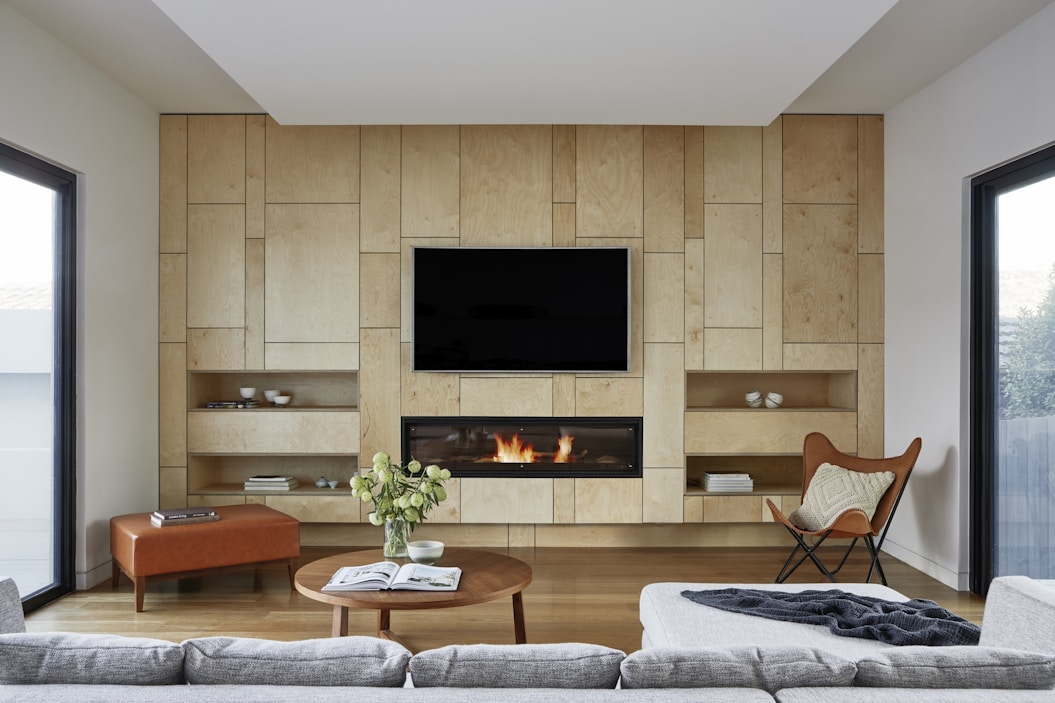 black flat screen tv on brown wooden tv rack