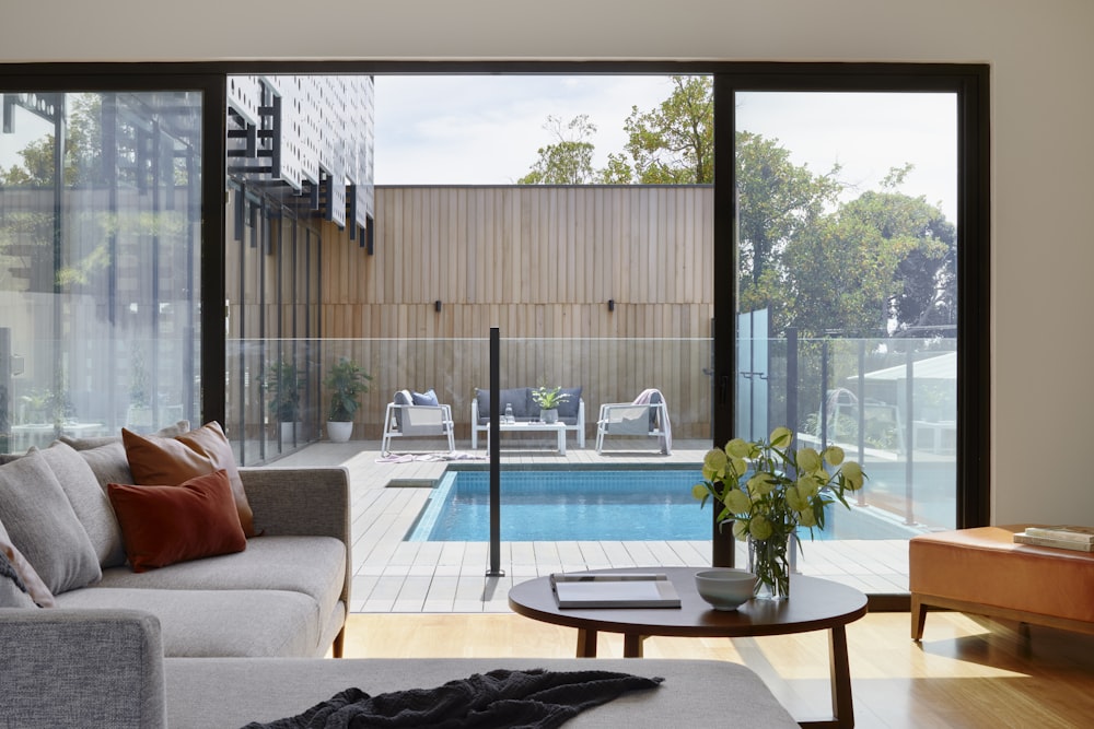 brown sofa near glass window