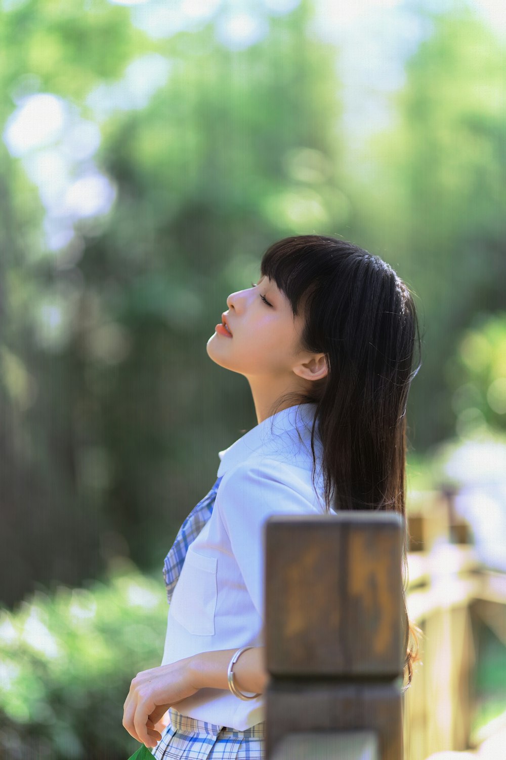 woman in white shirt looking down