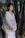 A serene photo of a person sitting quietly among tall bamboo stalks at dawn.