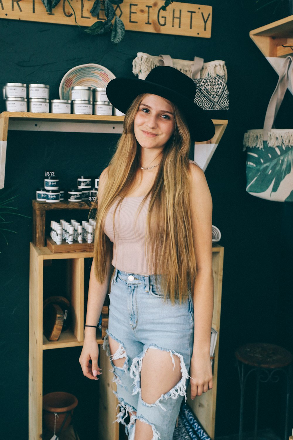 woman in blue denim shorts and black hat