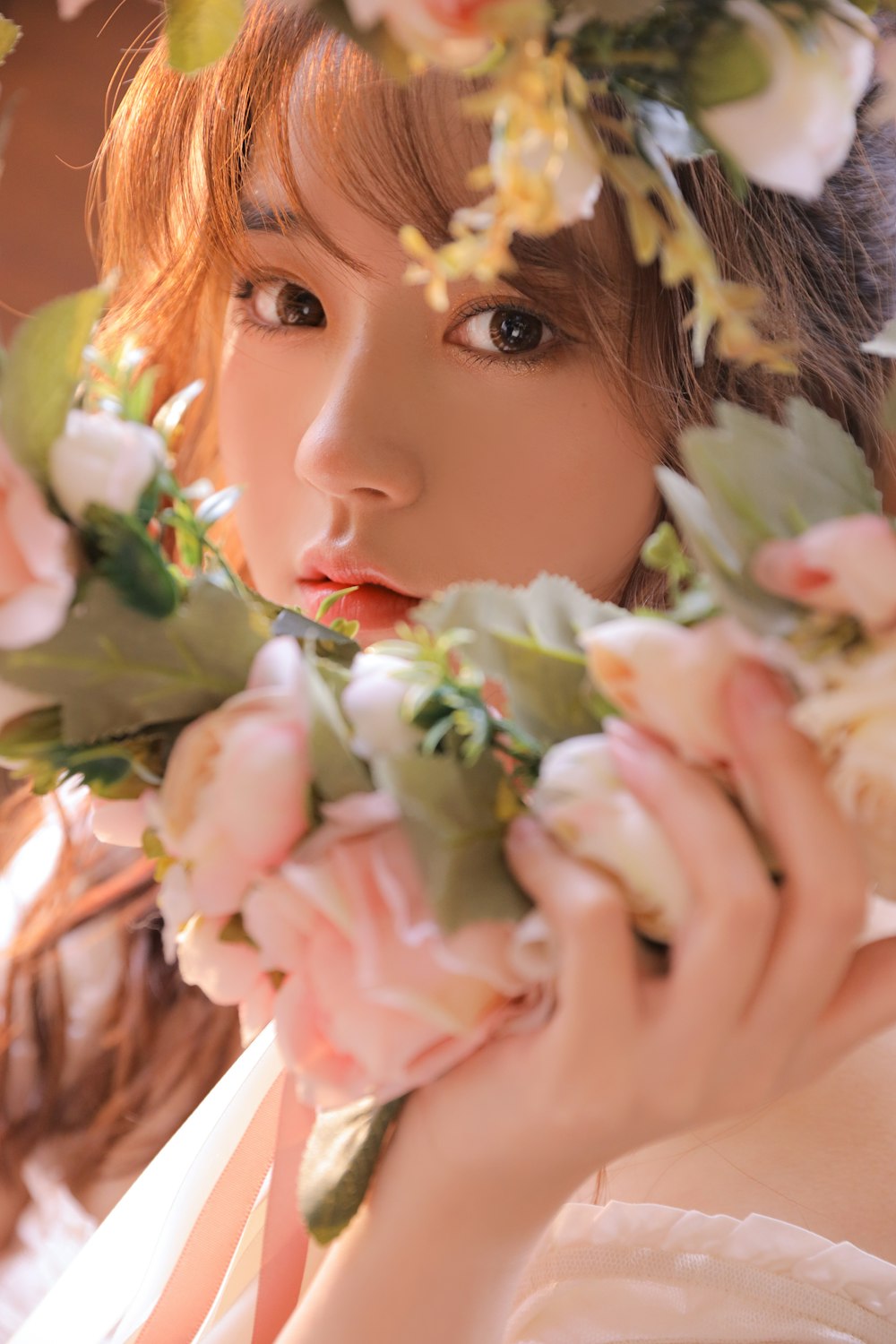 girl holding white and pink flower