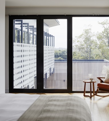 brown wooden armchair near glass window